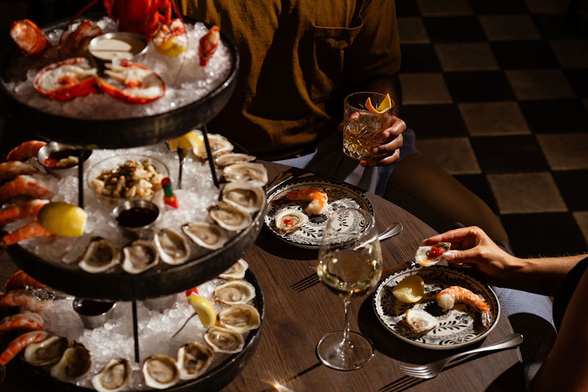 a group of people sitting at a table with a plate of food